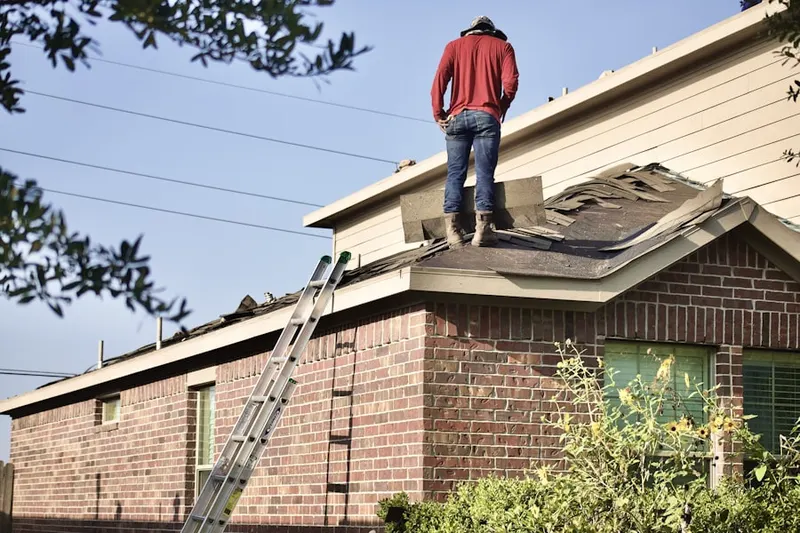 Professional roofer working on a residential roof in Manns Choice